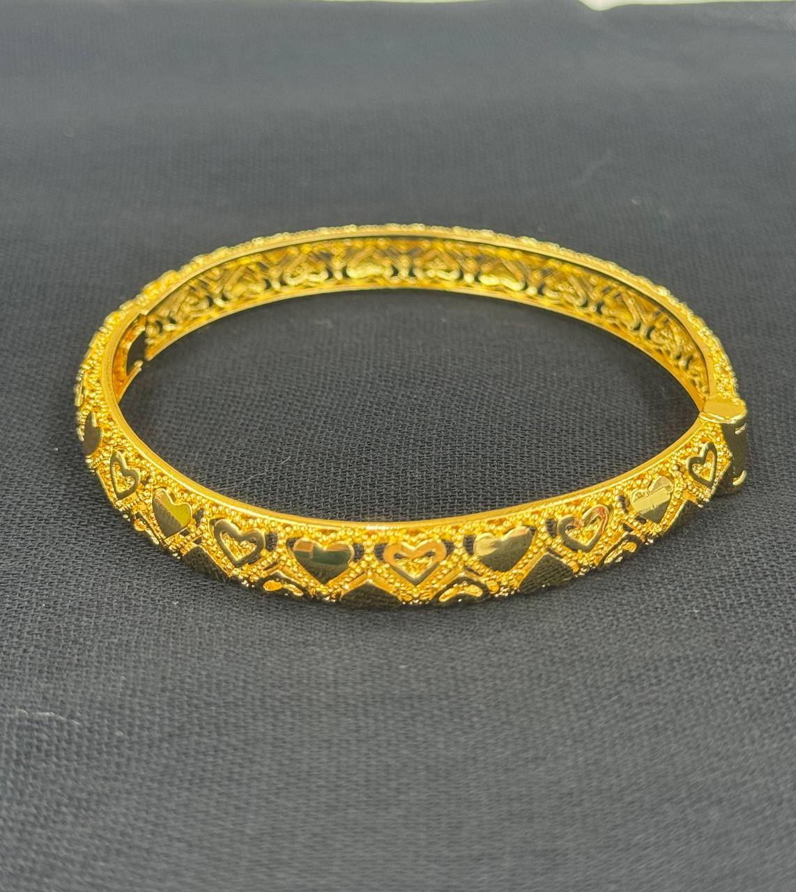 Palestinian Elegance heart design gold bangle bracelet in imitated gold with intricate cutout hearts
