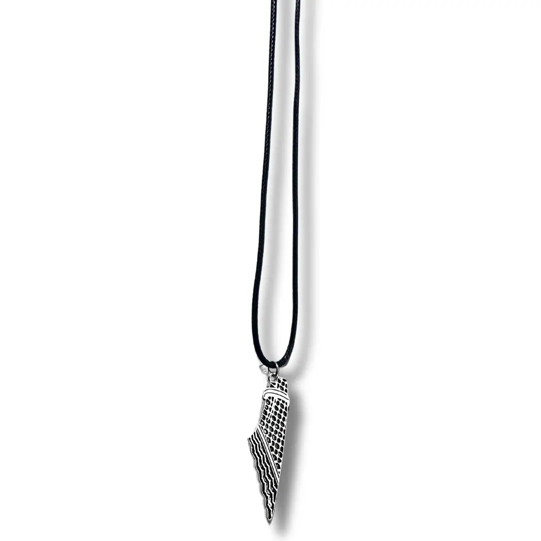 Handcrafted kuffiyeh necklace with black cord and silver pendant featuring traditional Palestinian design