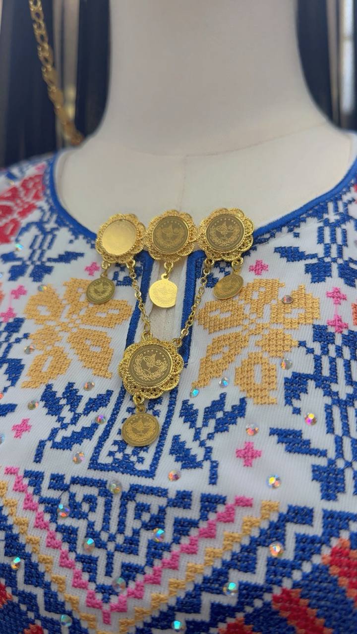 Palestinian Elegance traditional gold brooch made of imitated gold with coin details on embroidered garment