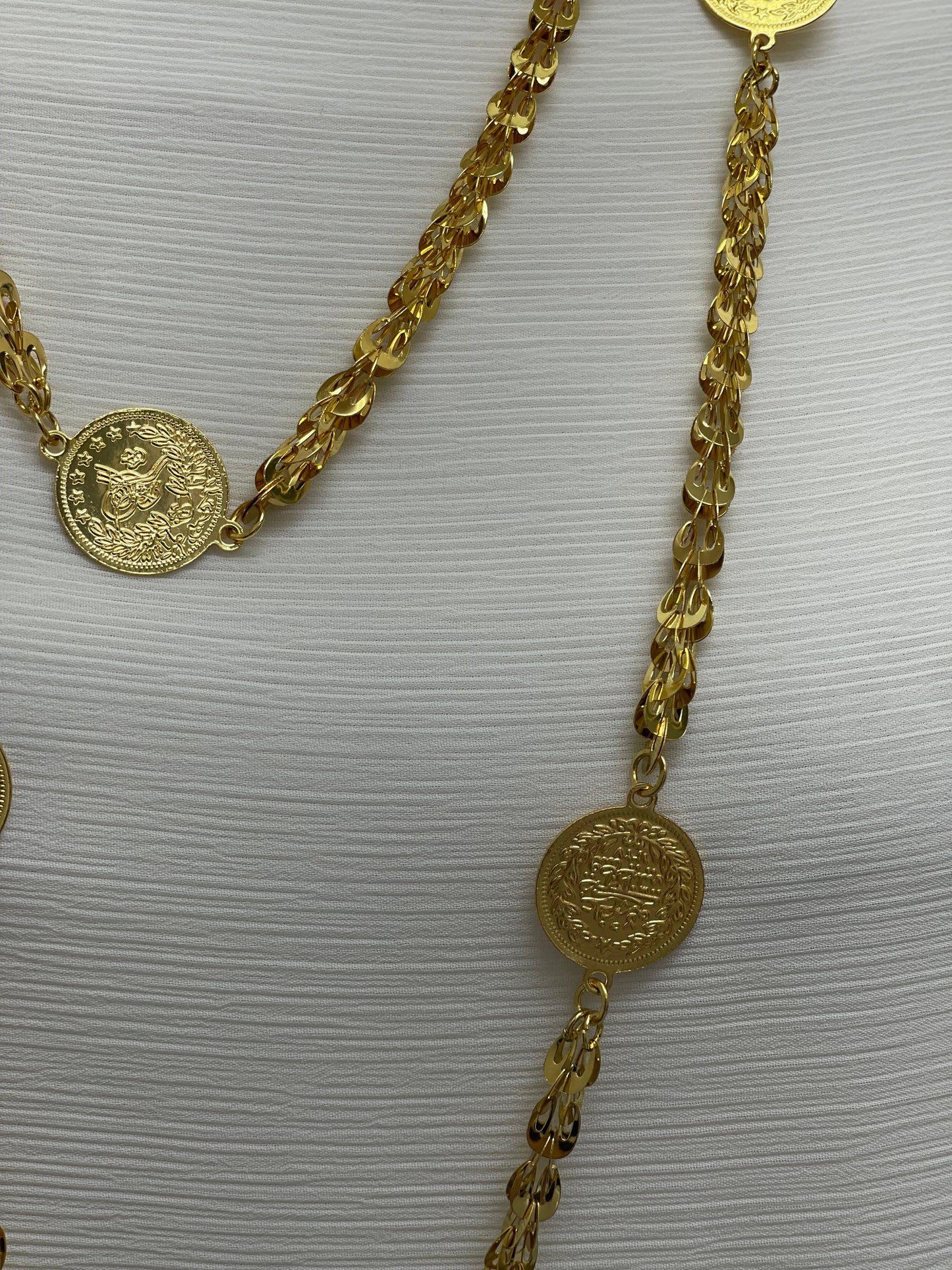 Gold Palestinian coin necklace featuring intricate coin pendants on a linked chain by Palestinian Elegance