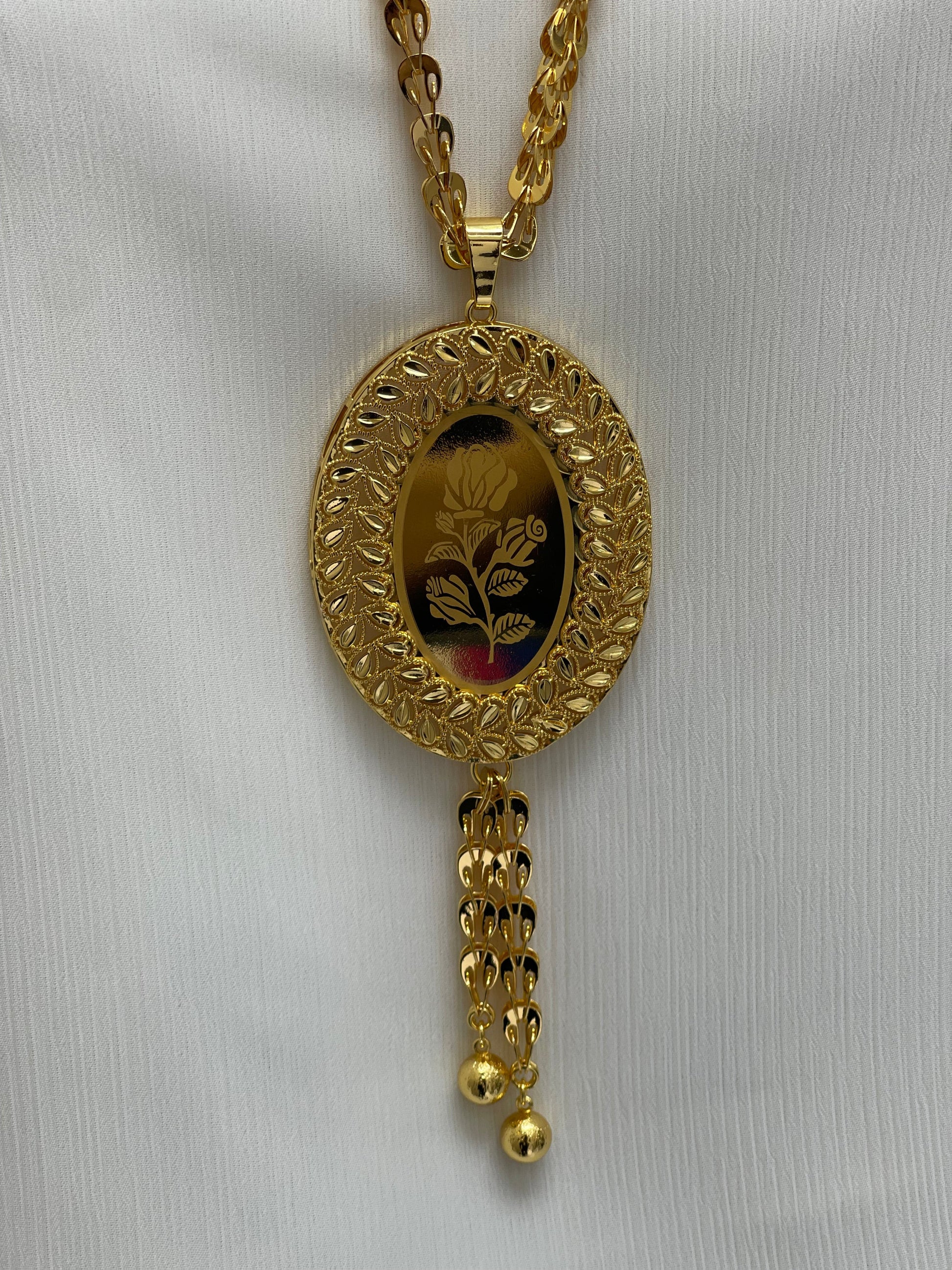 Palestinian Elegance long rose pendant necklace in gold with detailed floral design and chain tassels