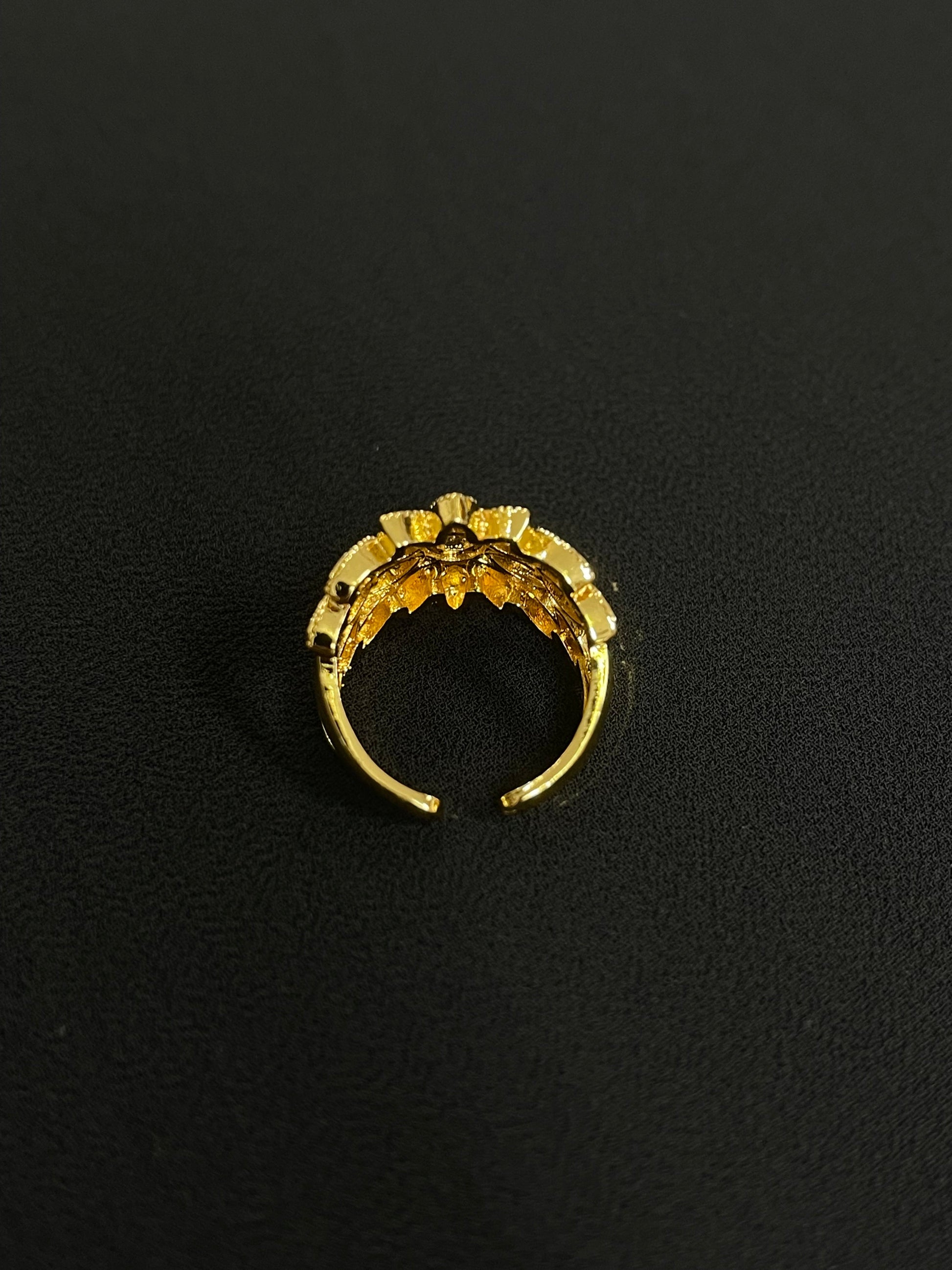 Palestinian gold jewelry set featuring a delicate gold ring with intricate floral design by Palestinian Elegance