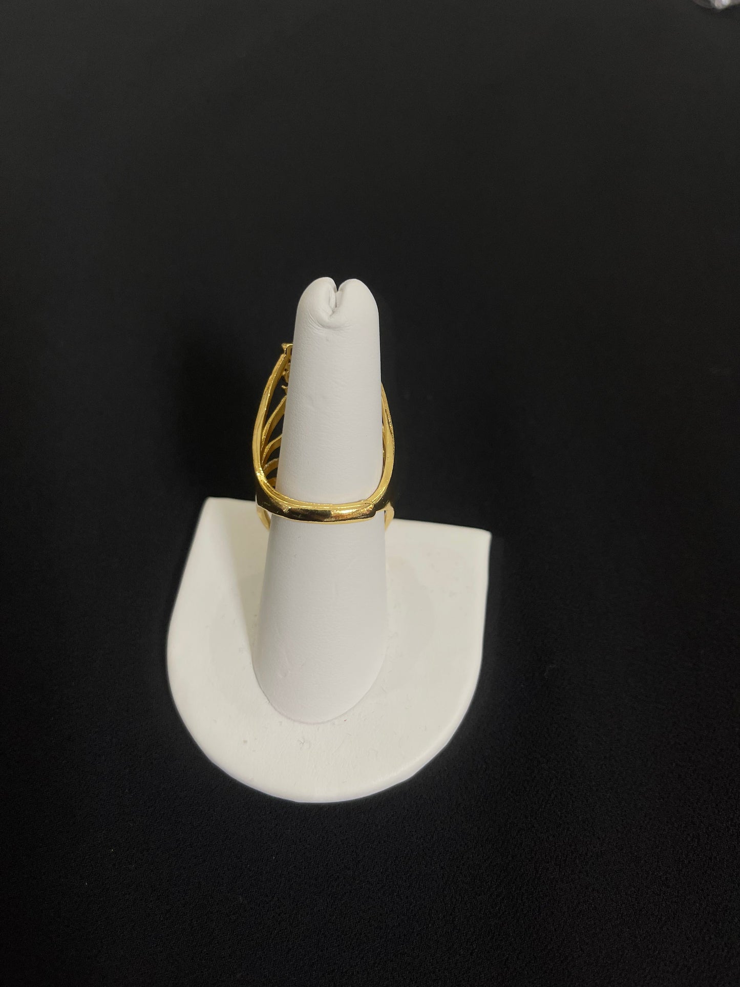 Elegant gold layered ring displayed on white ring holder by Palestinian Elegance