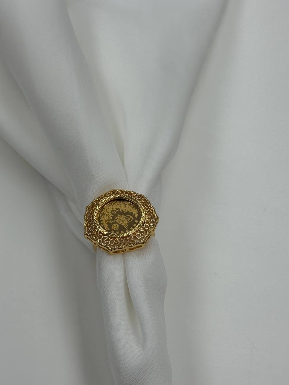 Palestinian Elegance falahi ring gold plated with intricate design on white fabric