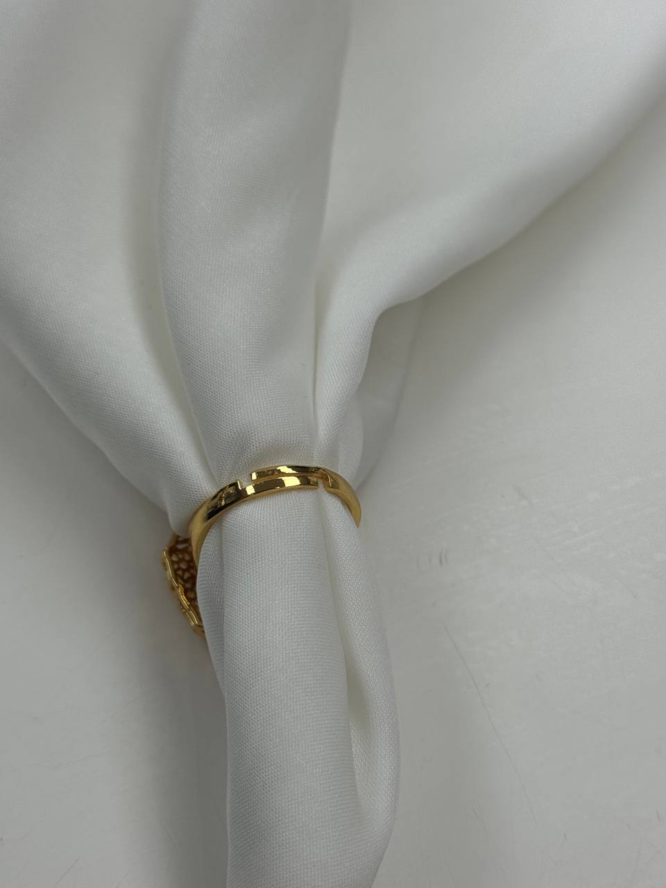 Palestinian Elegance falahi ring gold plated on white fabric showcasing imitated gold jewelry