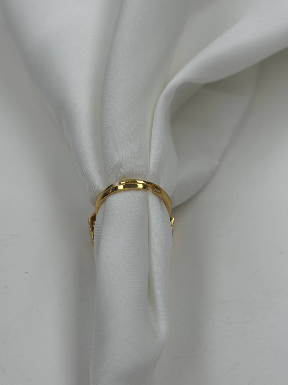 Palestinian Elegance falahi ring gold plated displayed on white fabric showcasing its shiny imitated gold finish