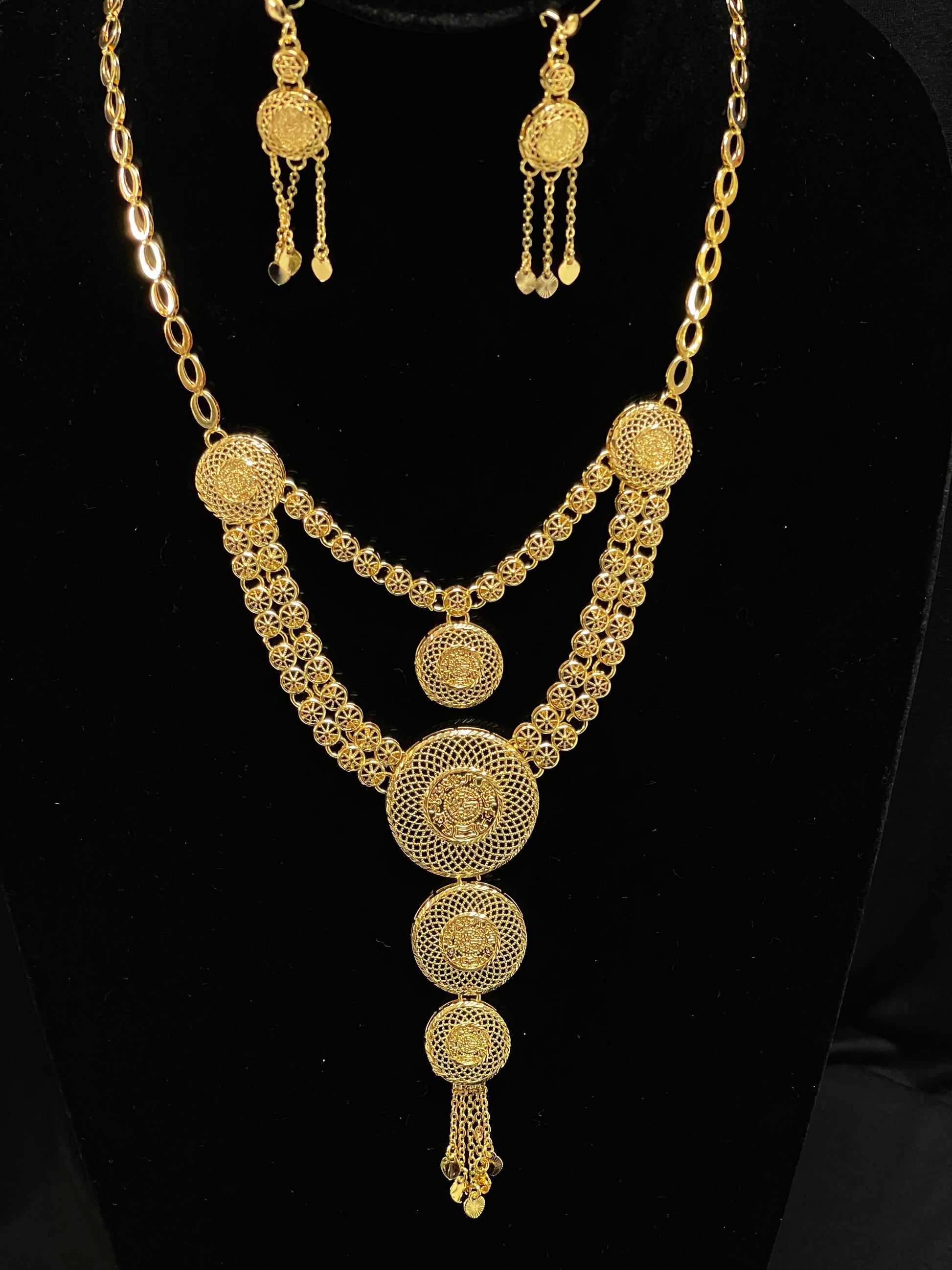 Palestinian Elegance gold layered necklace set with intricate circular filigree design and matching earrings