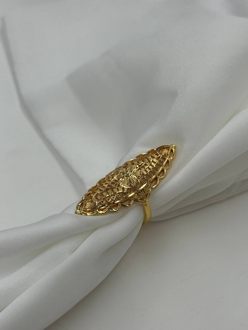 Palestinian Elegance imitated gold ring featuring a unique flower ring design on white fabric
