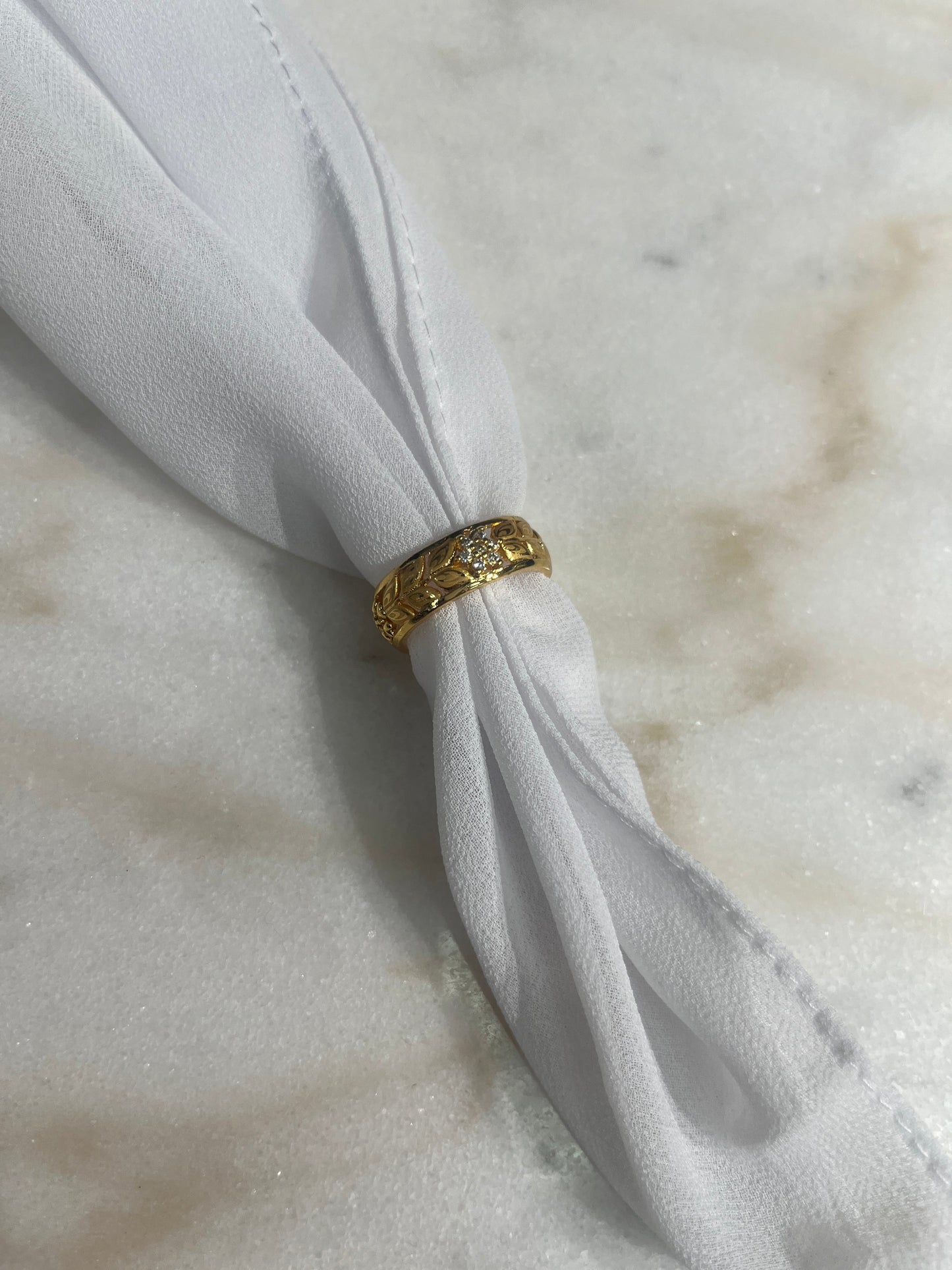 Palestinian Elegance imitated gold bracelet for weddings displayed on white fabric on a marble surface