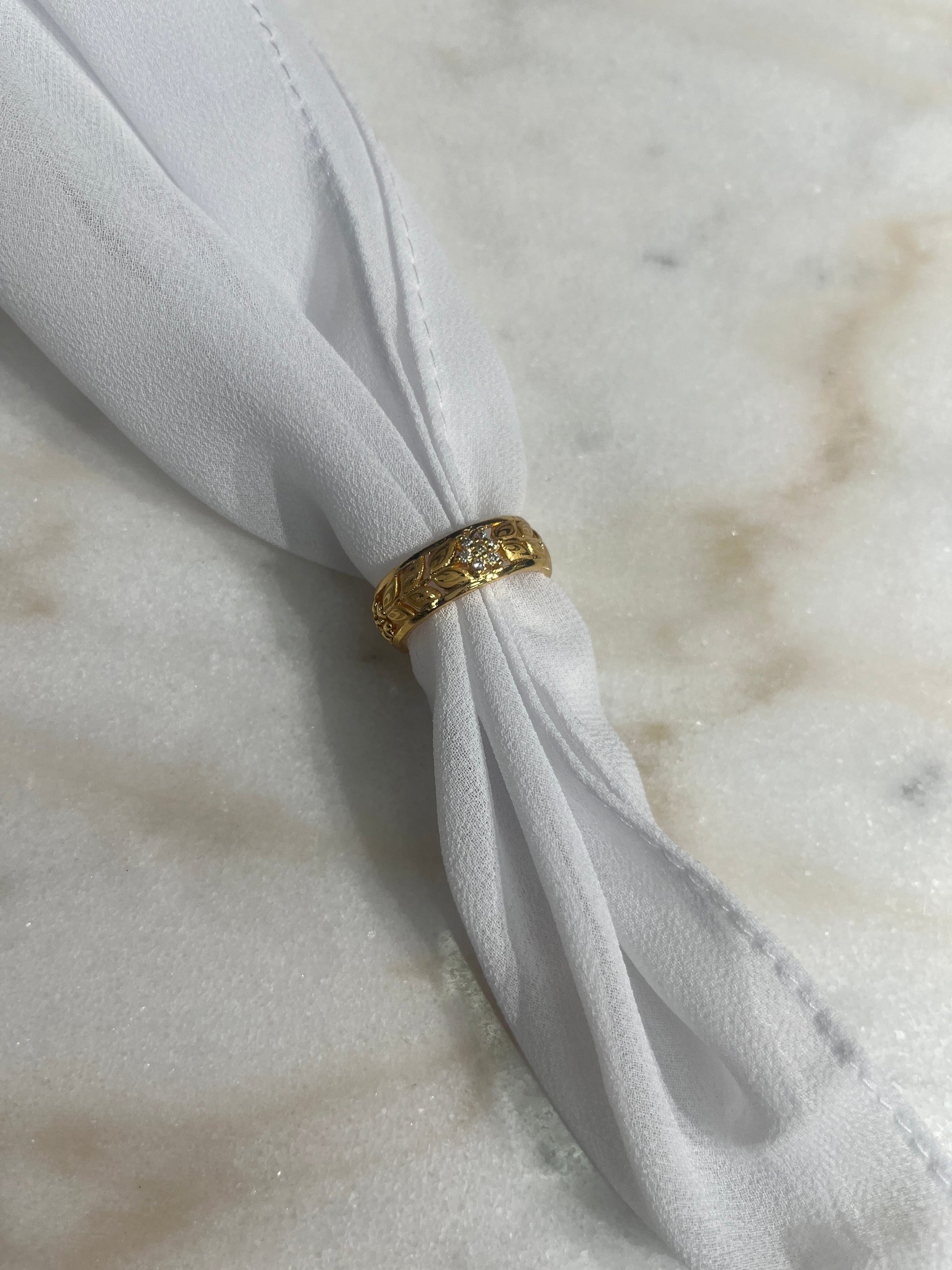 Palestinian Elegance imitated gold bracelet for weddings displayed on white fabric on a marble surface