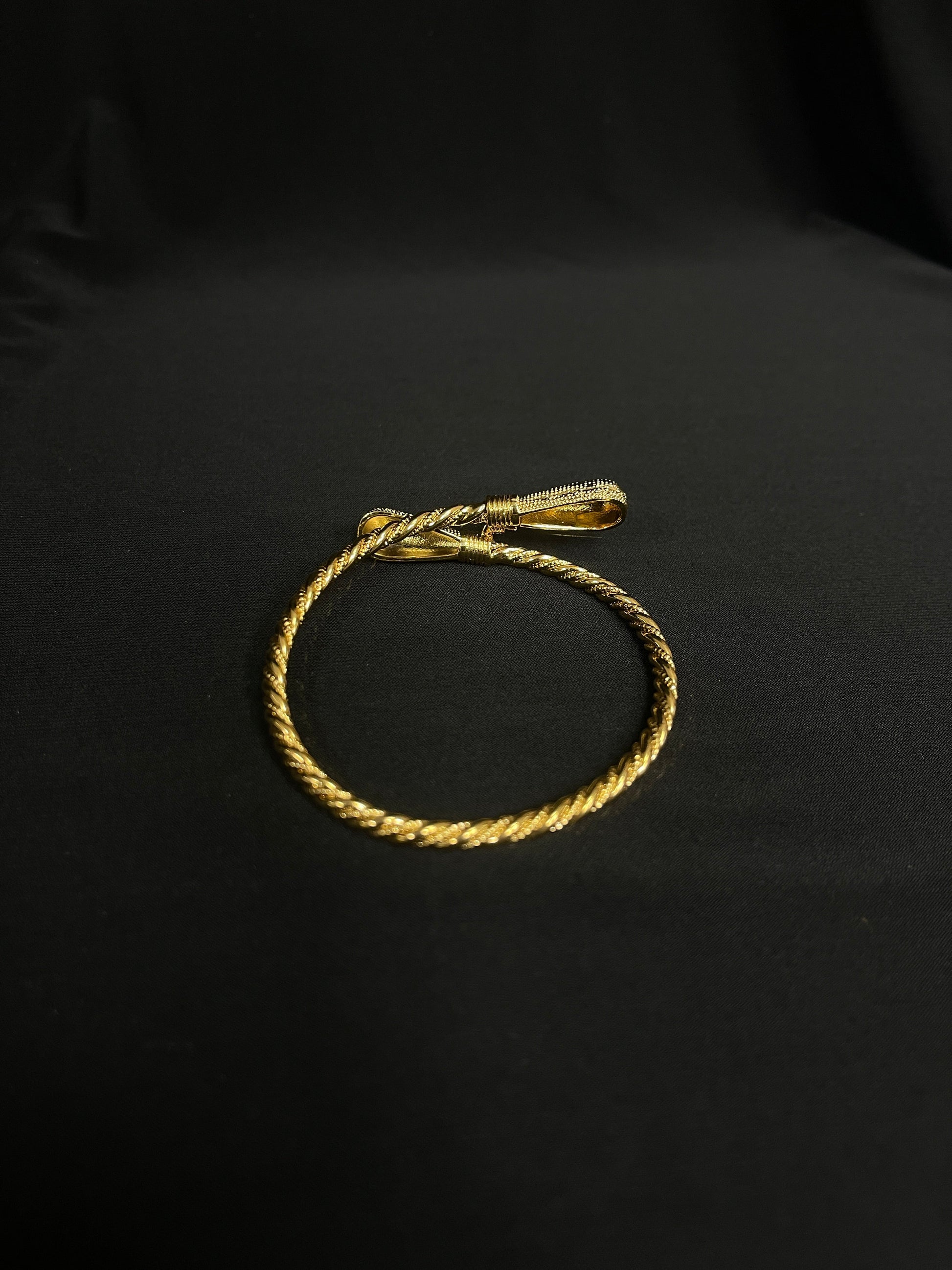 Palestinian Elegance imitated gold bracelet for women with twisted rope design on black background