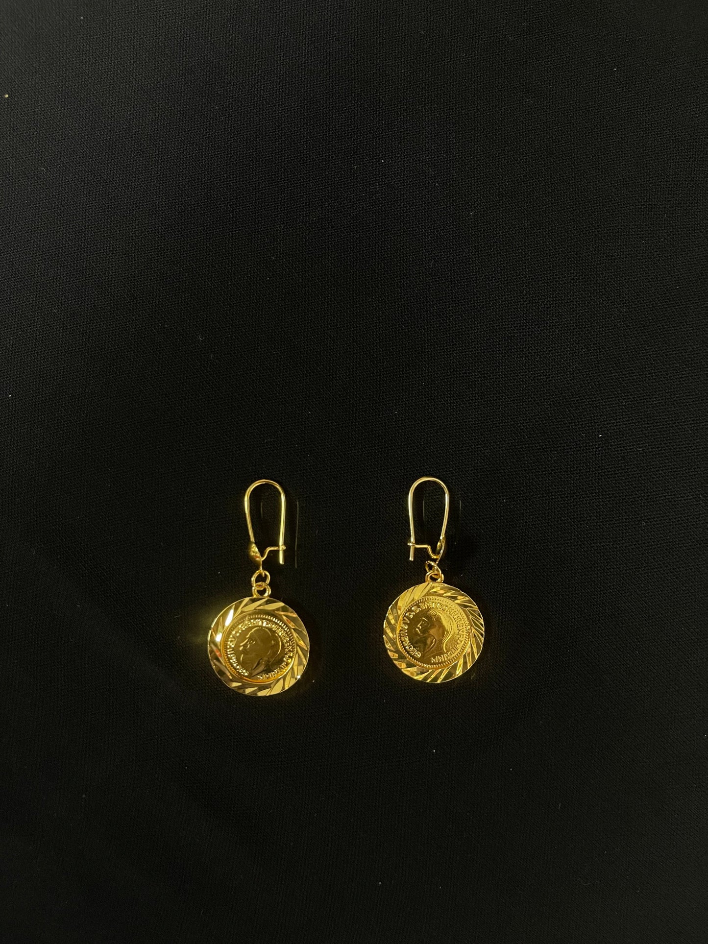 Palestinian Elegance imitated gold earrings with round coin pendant design on black background