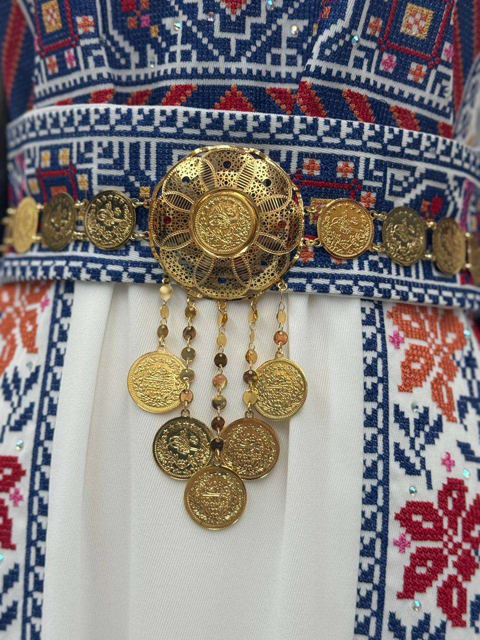 Palestinian Elegance imitated gold lera waist belt with intricate coin designs and hanging charms on traditional embroidered dress