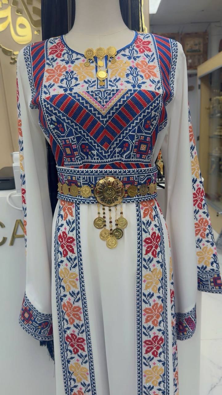 Palestinian dress featuring an imitated gold lera waist belt with intricate detailing and hanging ornaments