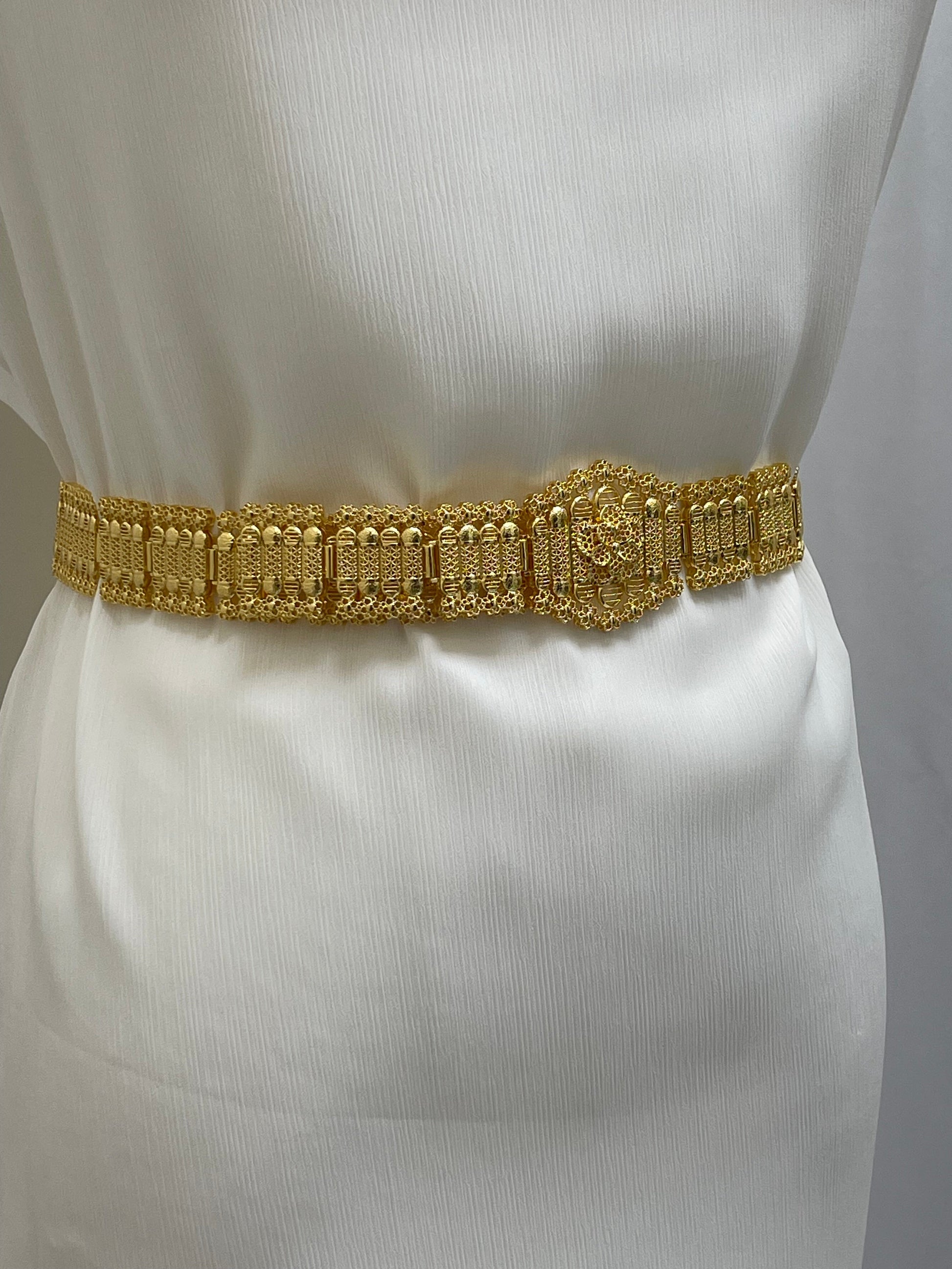 Kurdish gold style belt by Palestinian Elegance on a white dress showing intricate gold detailing