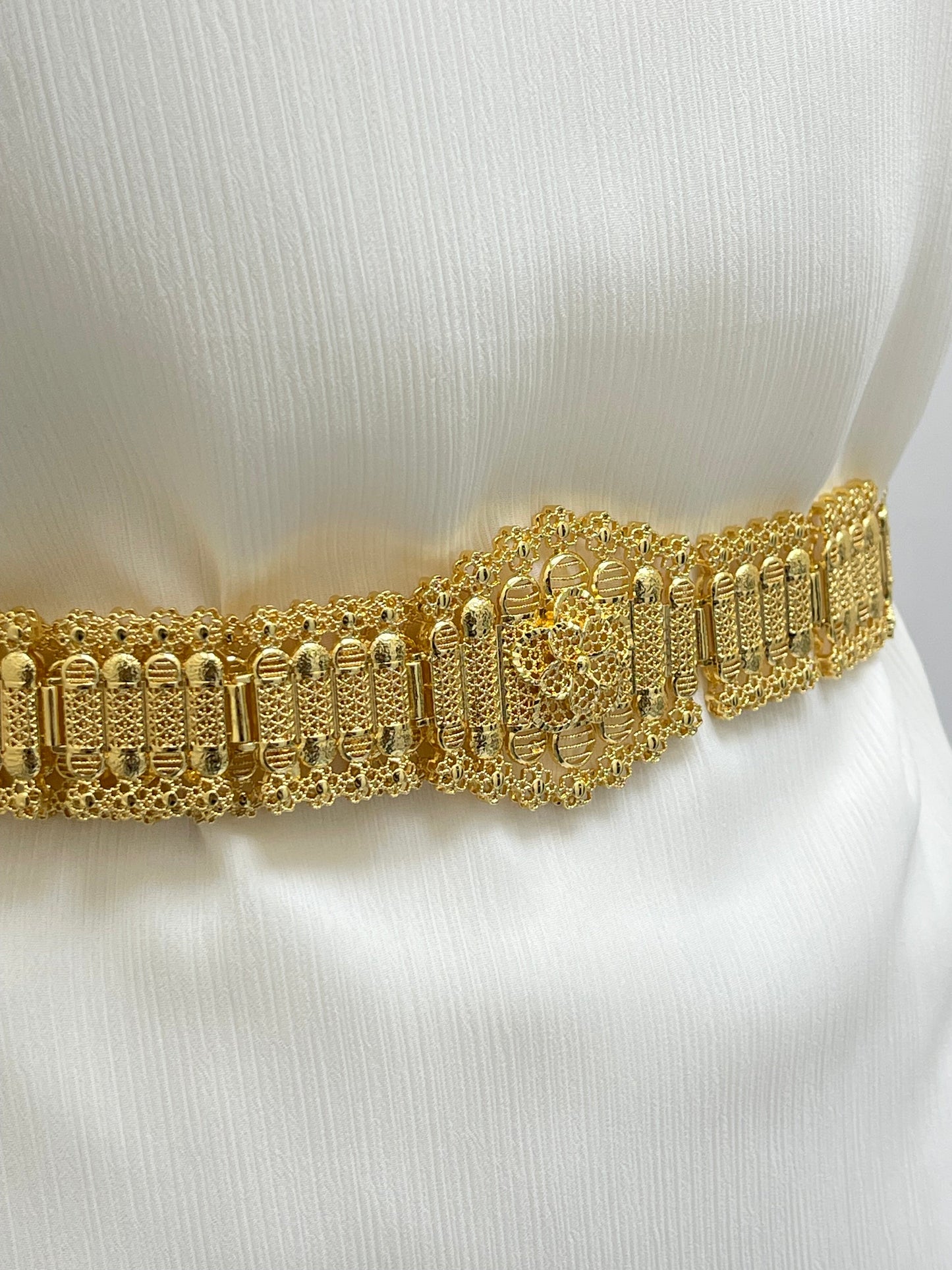 Palestinian Elegance Kurdish gold style belt with intricate gold detailing worn on white fabric