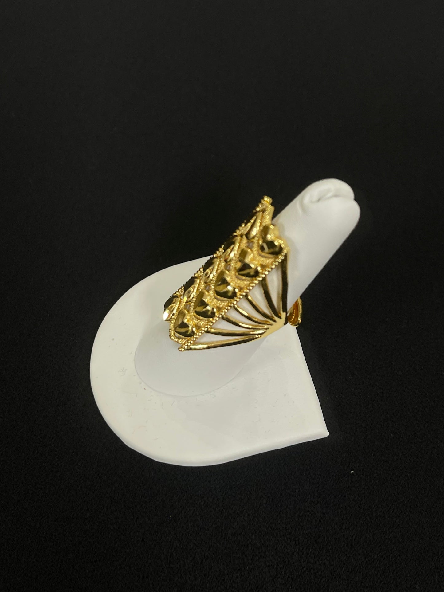 Layered hearts gold ring in imitated gold displayed on white ring holder by Palestinian Elegance