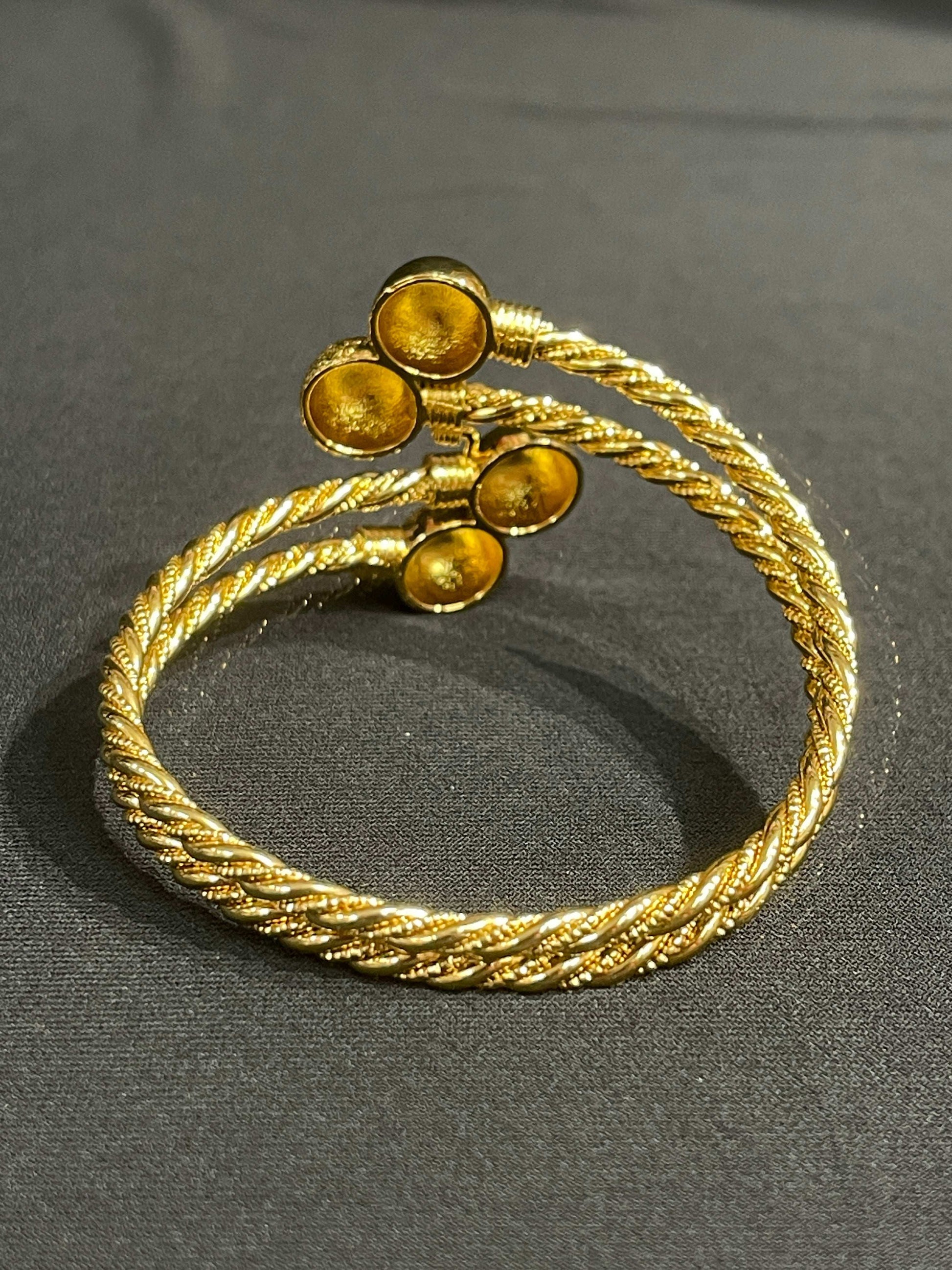 Elegant Mabroma Gold Bracelet by Palestinian Elegance with twisted rope design and circular end details