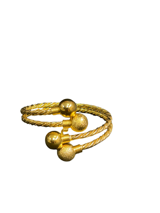 Palestinian Elegance Mabroma Gold Bracelet featuring twisted design with smooth and textured gold spheres