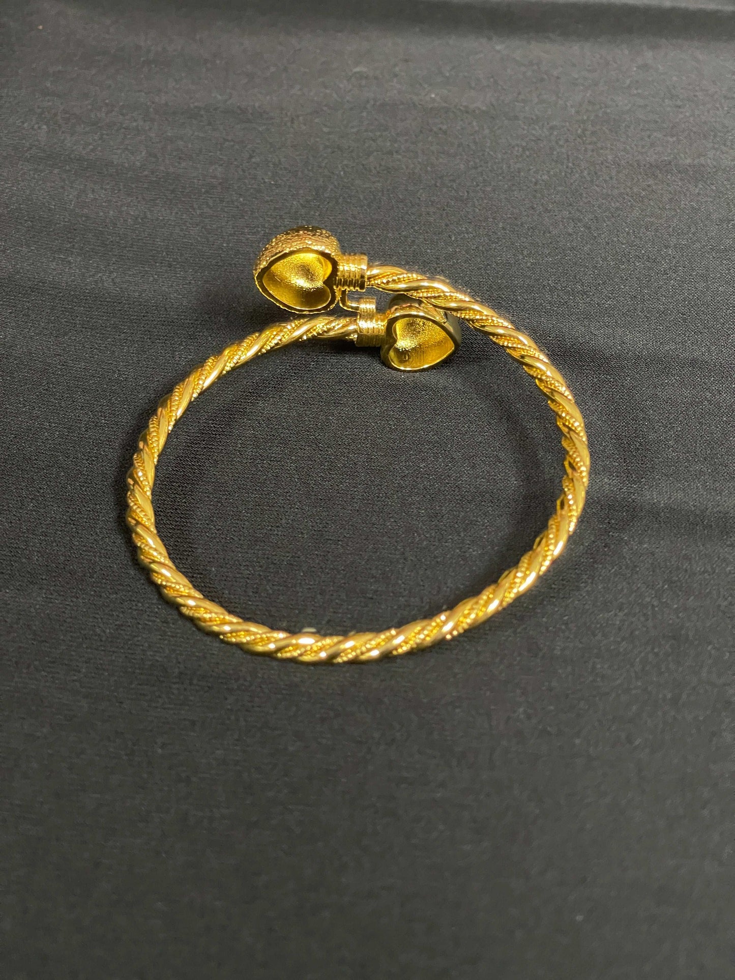 Mabroma Gold Heart Bracelet by Palestinian Elegance with twisted band and heart-shaped ends
