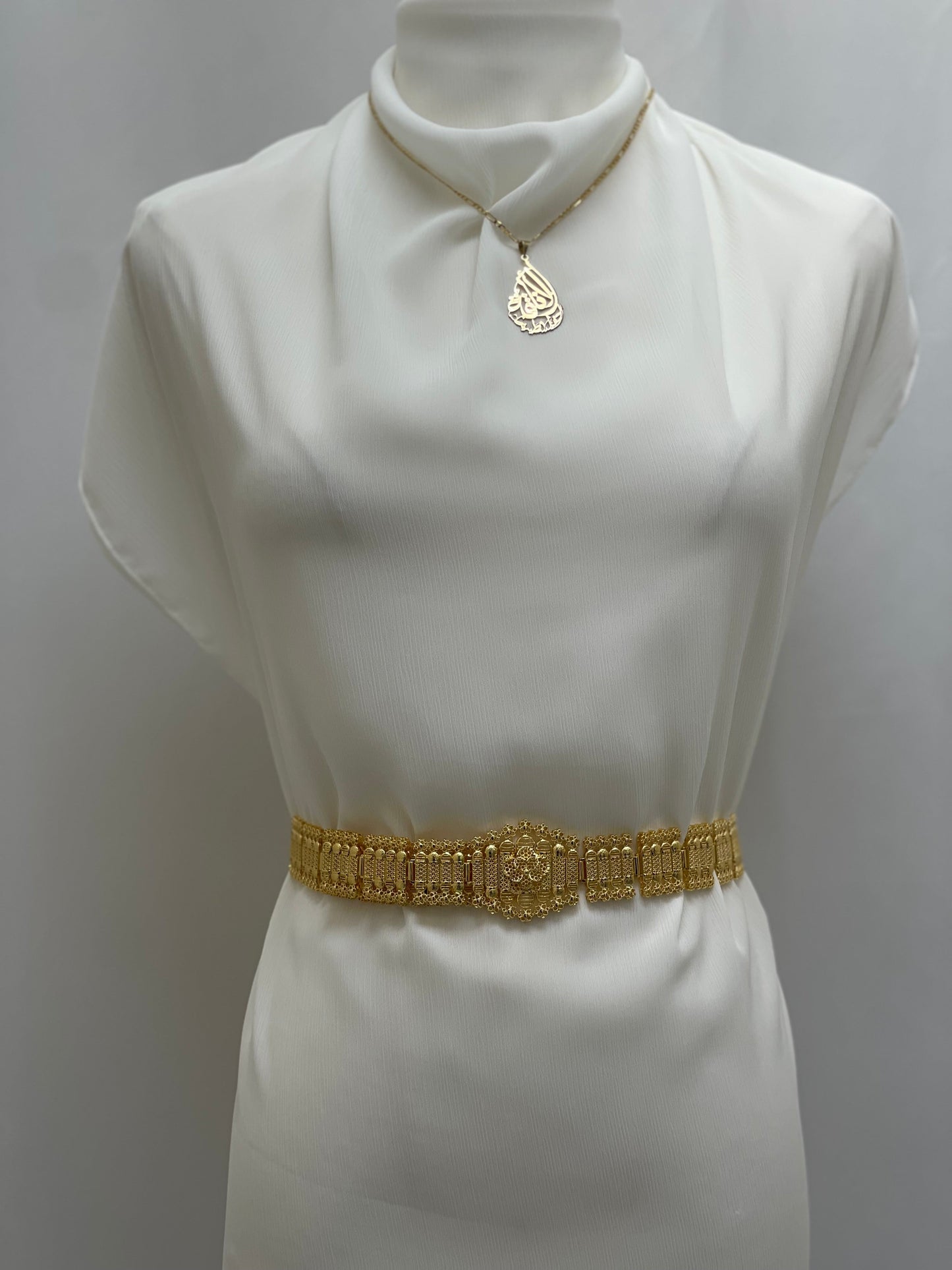 Palestinian Elegance imitated gold belt necklace displayed on white dress form