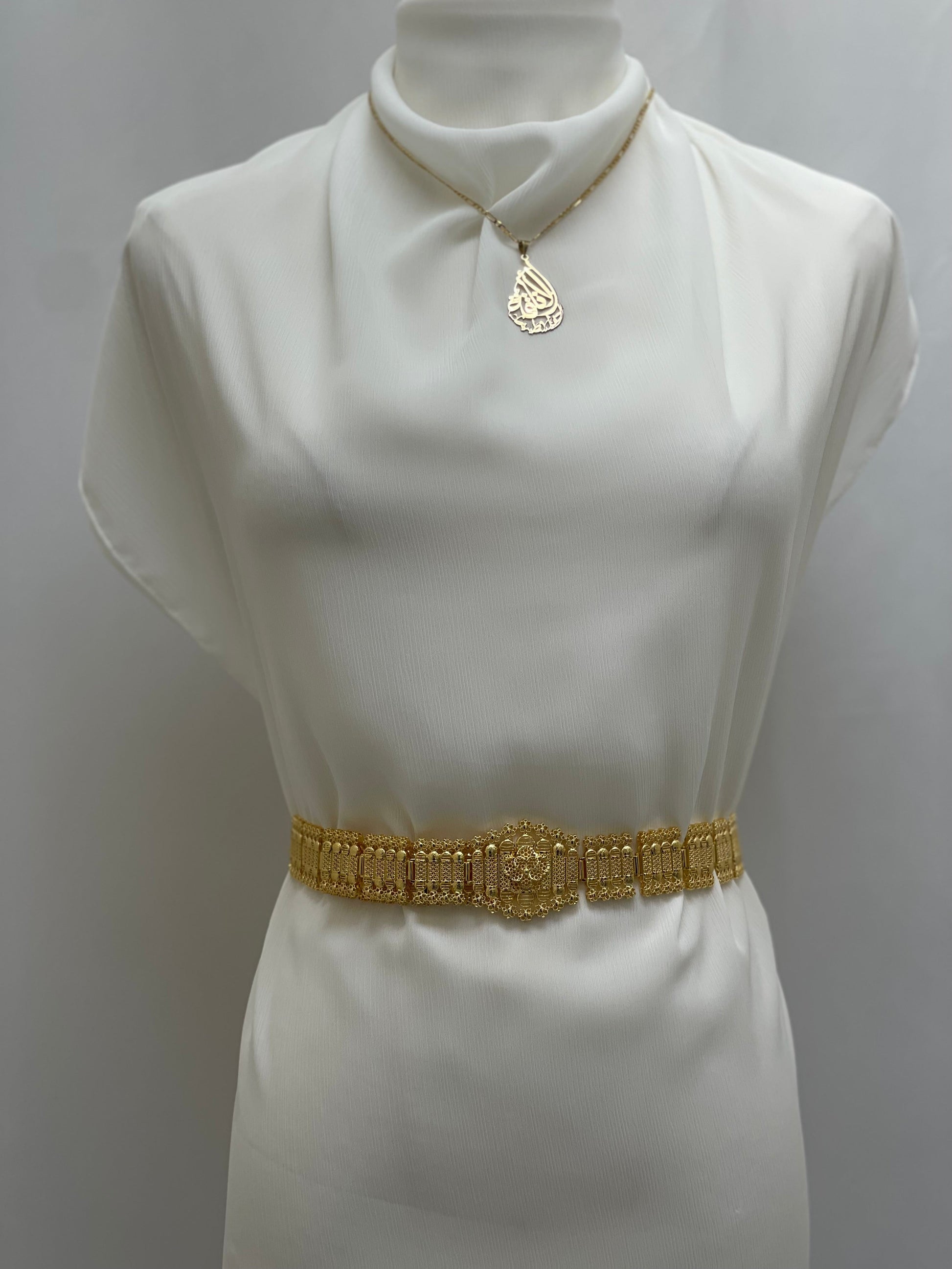 Palestinian Elegance imitated gold belt necklace displayed on white dress form