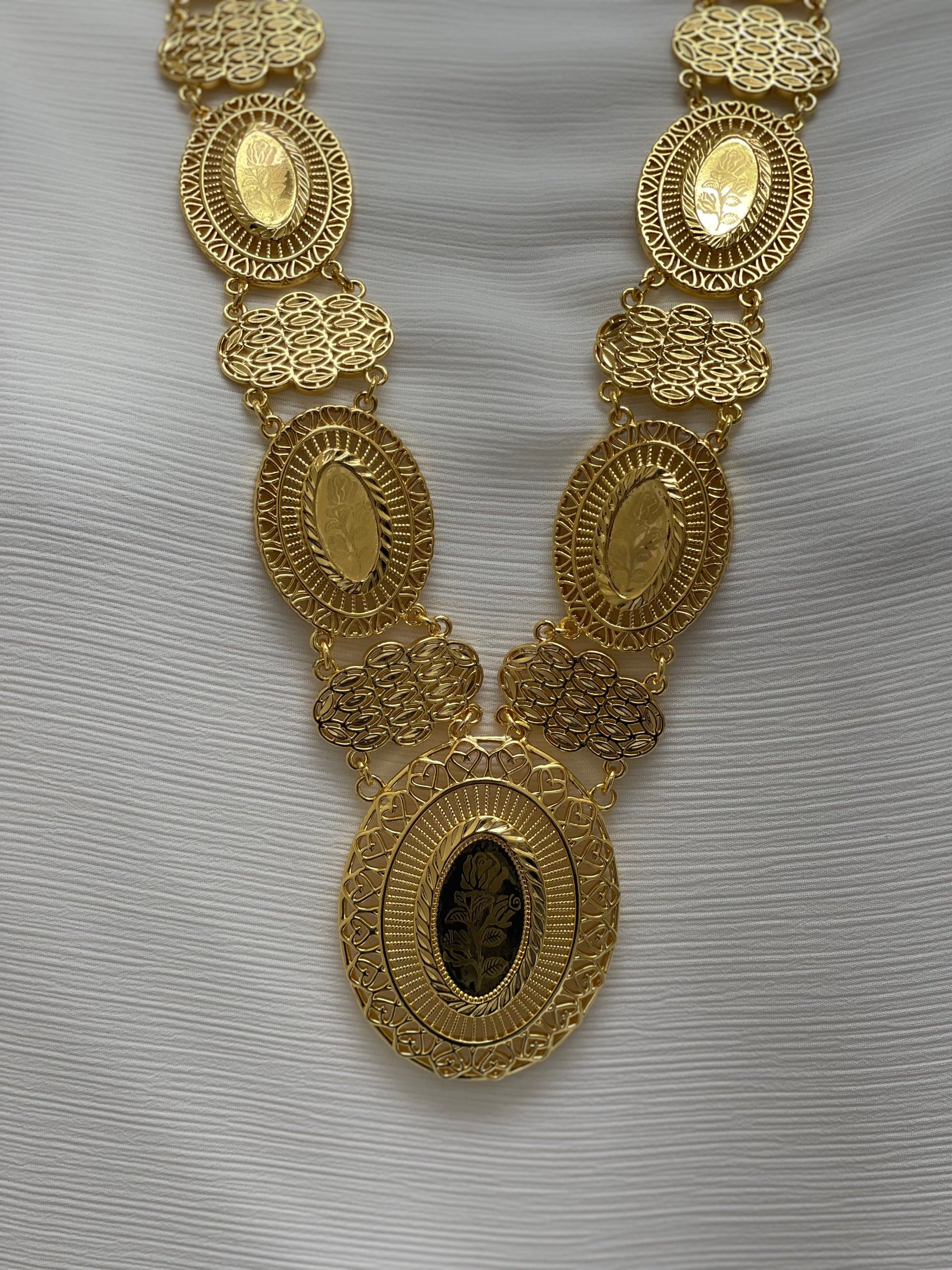 Palestinian embroidered necklace by Palestinian Elegance featuring intricate gold oval and filigree design