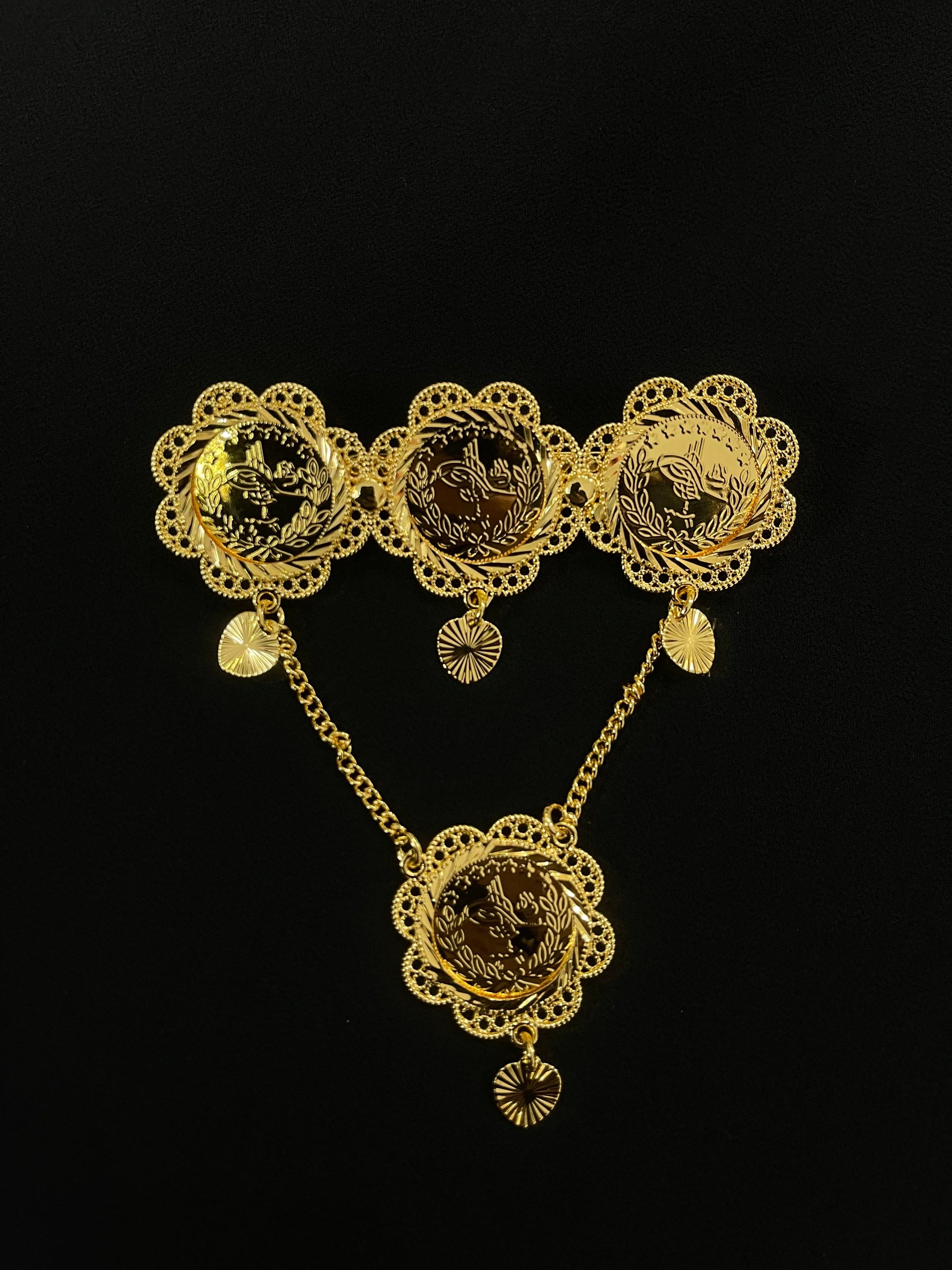 Palestinian gold pin jewelry with intricate floral designs and connected chains in gold tone