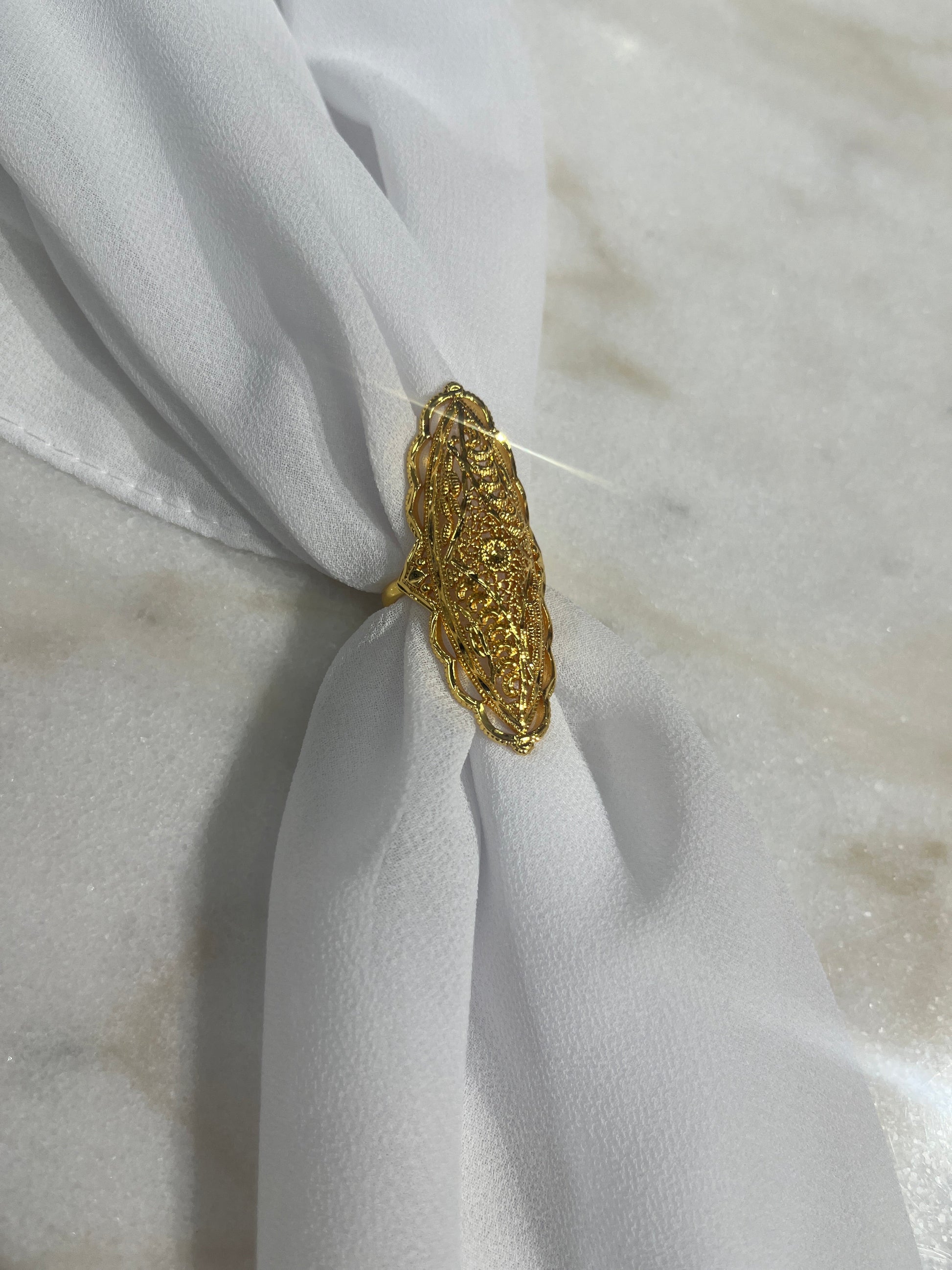 Elegant plated gold ring for women with intricate design by Palestinian Elegance on white fabric