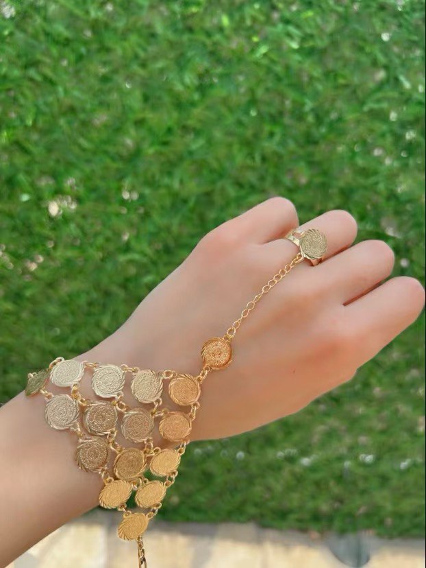 Gold kaff hand jewelry featuring intricate coin design on wrist and finger by Palestinian Elegance