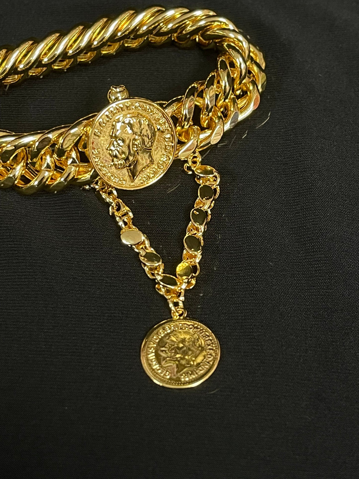 Imitated gold chain bracelet by Palestinian Elegance featuring coin charms on a black background